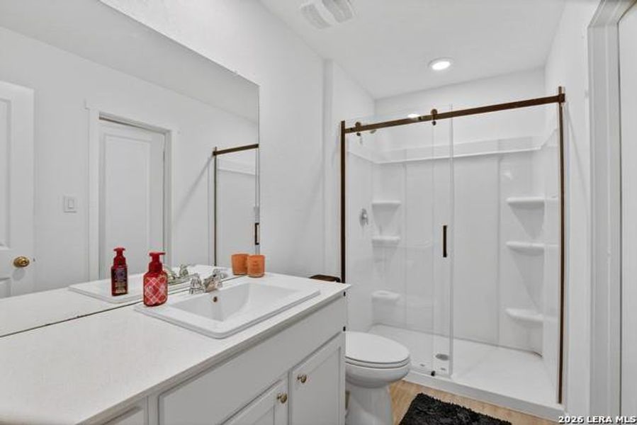 A well-appointed bathroom with a spacious walk-in shower and a modern vanity. A well-appointed bathroom with a spacious walk-in shower and a modern vanity.