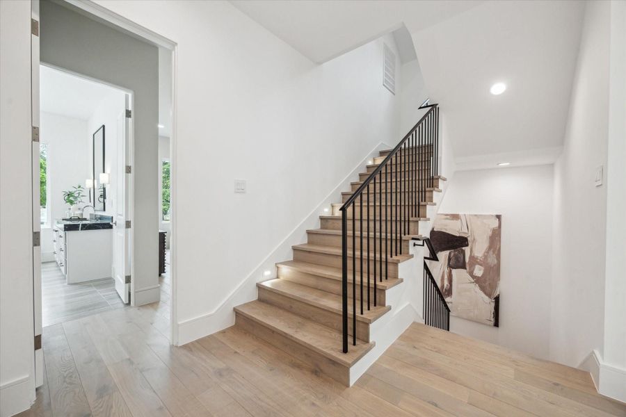 Second floor landing area with stairs and elevator shaft leading to third floor gameroom and final bedroom with en-suite bath. Second floor landing area with stairs and elevator shaft leading to third floor gameroom and final bedroom with en-suite bath.