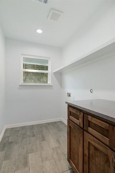 Laundry room with light wood-type flooring, hookup for a washing machine, and recessed lighting Laundry room with light wood-type flooring, hookup for a washing machine, and recessed lighting