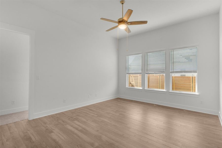 Unfurnished room with light wood finished floors and a ceiling fan