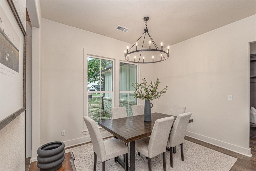 Dining area featuring wood finished floors and hanging lights