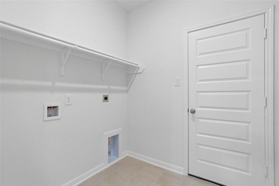 The laundry room features a streamlined shelf that keeps all your essentials neatly within reach. The laundry room features a streamlined shelf that keeps all your essentials neatly within reach.