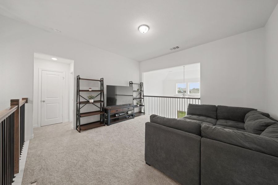 The game room overlooks the family room, creating an airy feel.