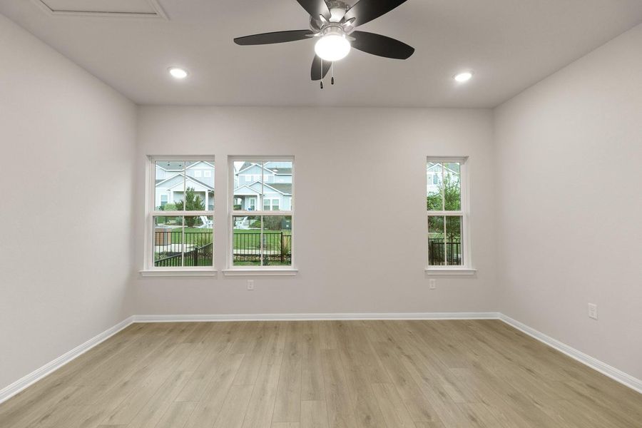 Bright room with light-colored flooring, recessed lighting, and a ceiling fan