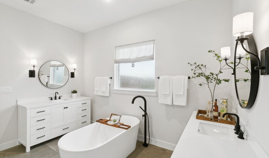 Primary suite bath tub with matte black faucet and fixtures