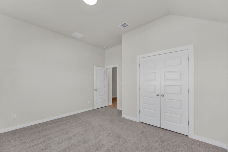 Bedroom in the Evelyn Pecos model home in Austin TX by Trophy Signature Homes