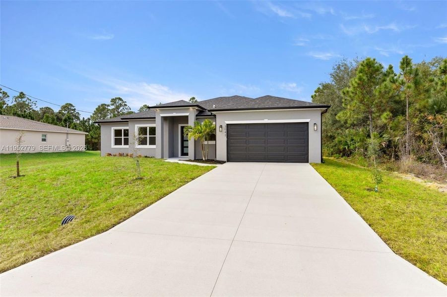 Front exterior of a new home in , Palm Bay, FL, highlighting curb appeal (Image 1). Front exterior of a new home in , Palm Bay, FL, highlighting curb appeal (Image 1).