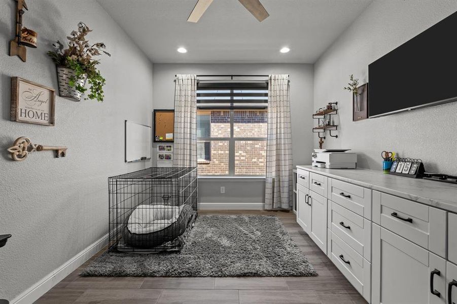 Office featuring ceiling fan and dark hardwood / wood-style floors