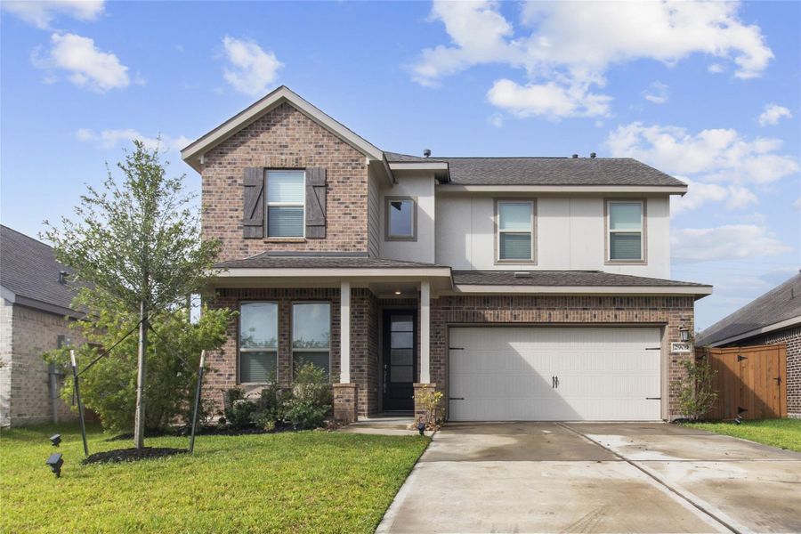 Charming two-story home with a classic brick façade, featuring a spacious two-car garage and a welcoming front porch. Lush landscaping enhances its curb appeal. Charming two-story home with a classic brick façade, featuring a spacious two-car garage and a welcoming front porch. Lush landscaping enhances its curb appeal.