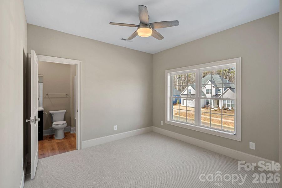 A third Guest Bedroom offers an ensuite bath and a spacious walk-in closet with custom shelving.