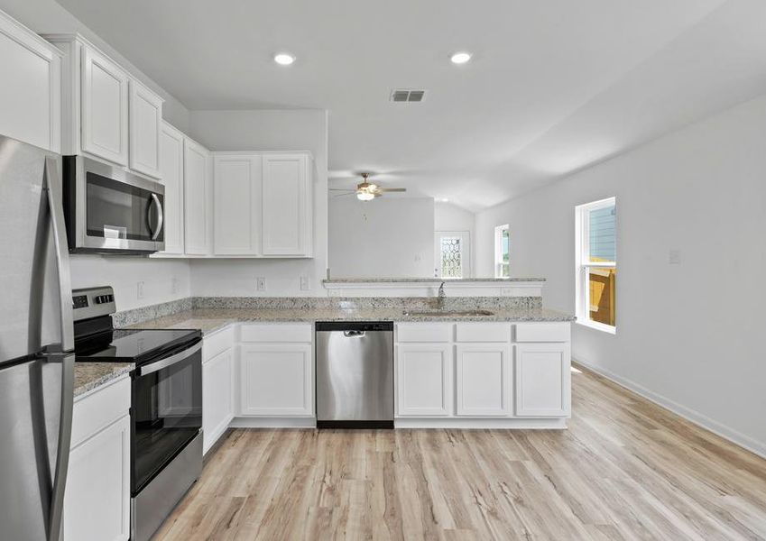 Granite countertops and stainless steel appliances fill the chef-ready kitchen