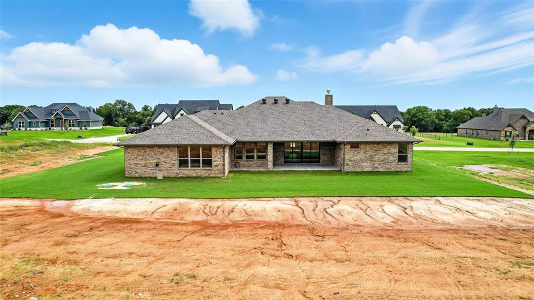 Front exterior of a new home in Rocky Top Ranch, Reno, TX, highlighting curb appeal (Image 2). Front exterior of a new home in Rocky Top Ranch, Reno, TX, highlighting curb appeal (Image 2).