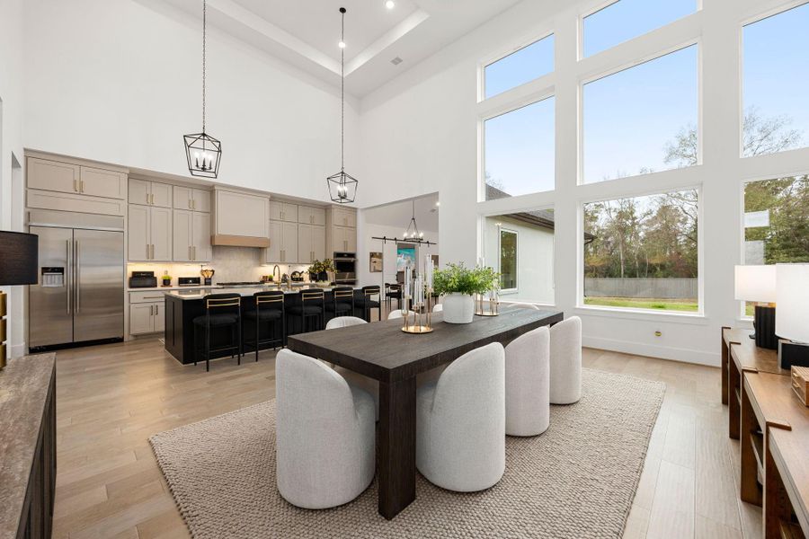Kitchen and Dining area with high ceilings and large windows for ample natural light. Make memories gathered around the table with your family and friends!