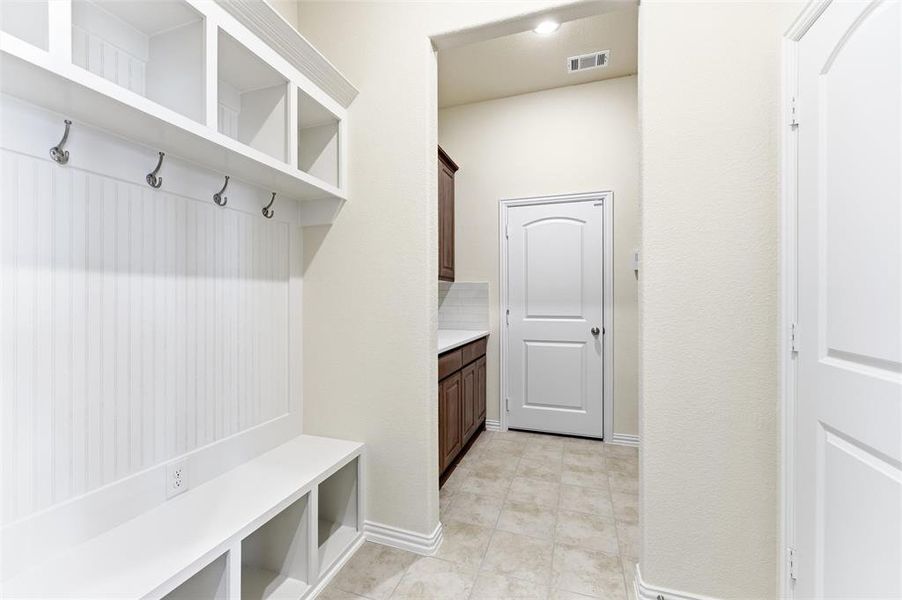 Mudroom with light tile patterned floors