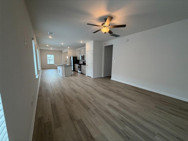 Unfurnished living room featuring light wood-type flooring, ceiling fan, and recessed lighting