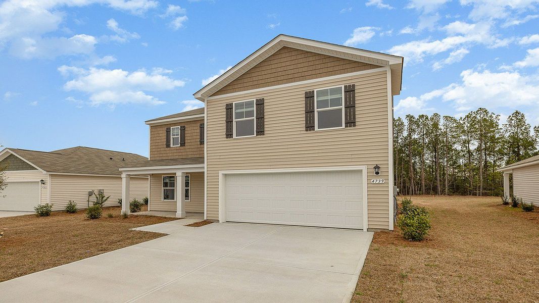 Front exterior of a new home in The Meadows at Wildwood Village, Shallotte, NC, highlighting curb appeal (Image 2).