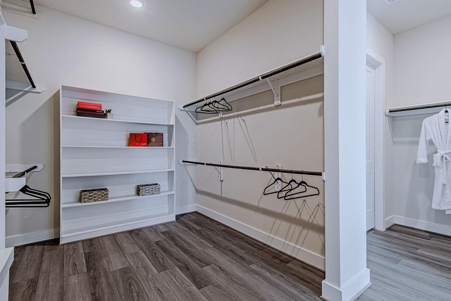 Walk-in closet with built-in shelving and generous storage space
