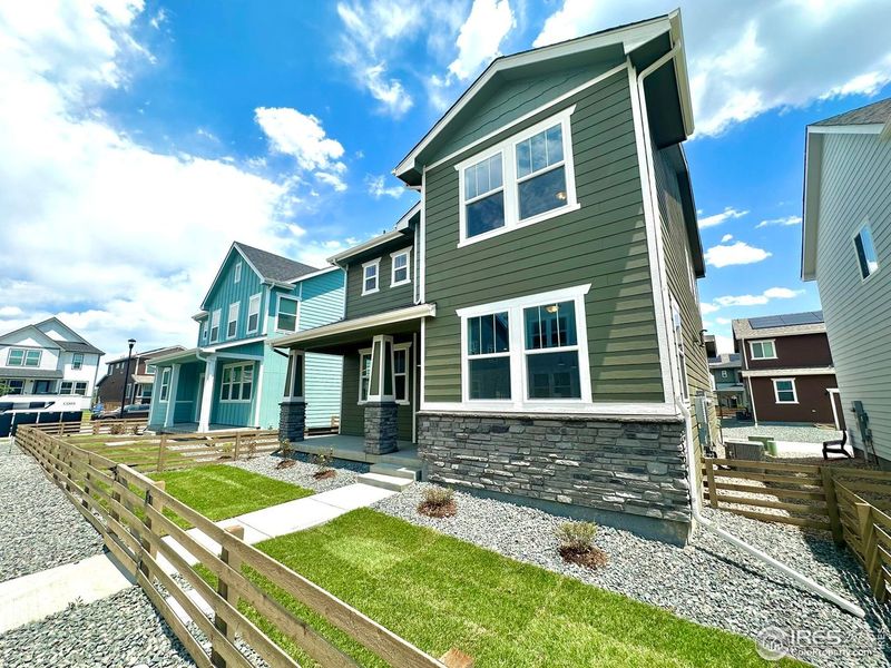 Front exterior of a new home in Waterfield, Fort Collins, CO, highlighting curb appeal (Image 27). Front exterior of a new home in Waterfield, Fort Collins, CO, highlighting curb appeal (Image 27).