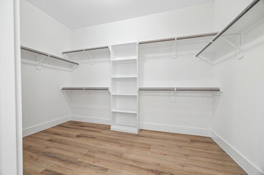 Love this large walk-in closet with plenty of space for all your wears!