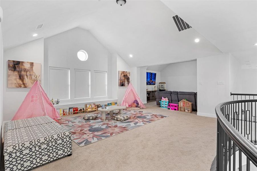 Recreation room featuring carpet, vaulted ceiling, recessed lighting, and visible vents