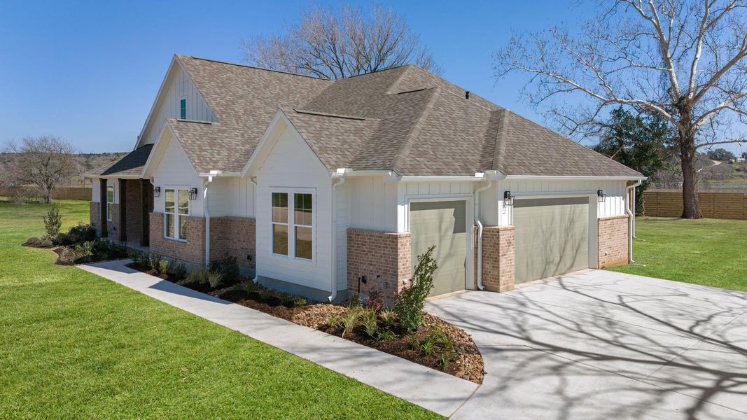 Front exterior of a new home in , Smithville, TX, highlighting curb appeal (Image 23). Front exterior of a new home in , Smithville, TX, highlighting curb appeal (Image 23).
