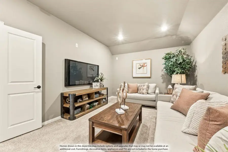 Living room with vaulted ceiling, wall-mounted TV, sectional sofa, and wood coffee table on carpet flooring