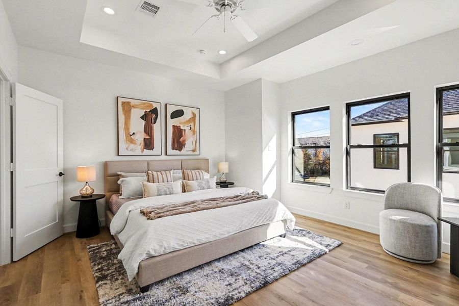 Lovely primary bedroom with tray ceilings