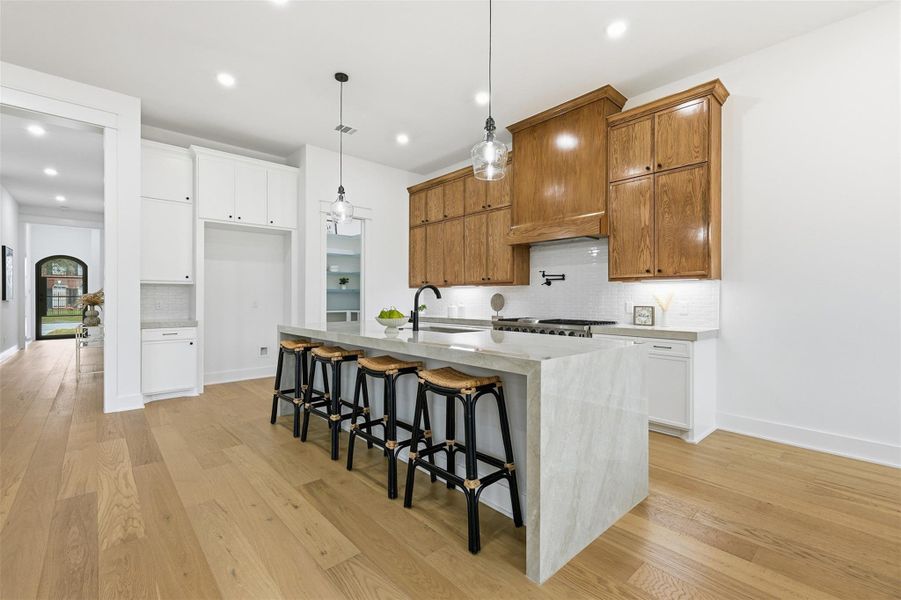 Soft-close cabinetry and drawers enhance everyday ease, complemented by an oversized undermount sink and a 42-inch refrigerator to be installed.