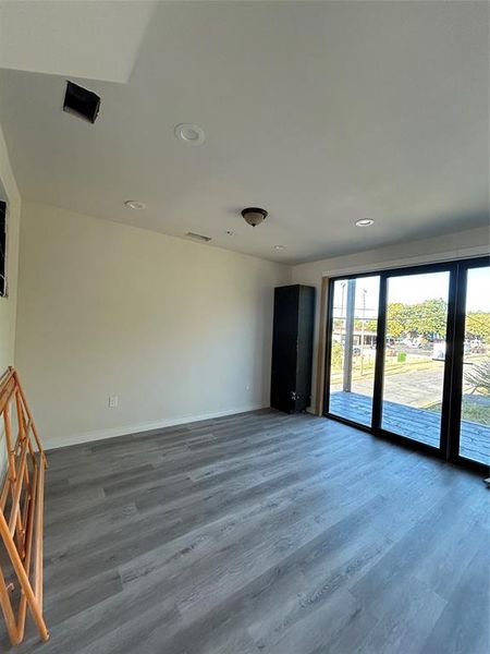 Unfurnished room featuring dark wood finished floors and recessed lighting