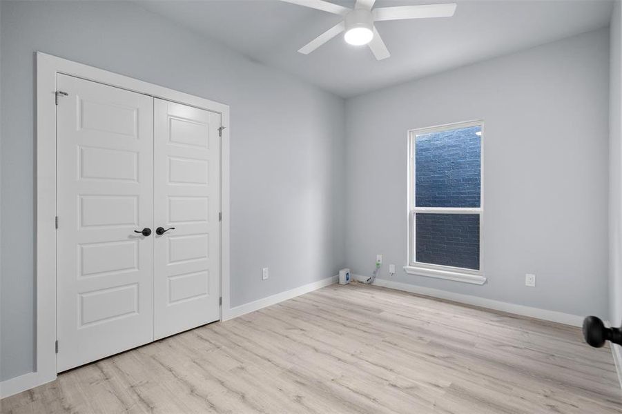 Spare room featuring a ceiling fan and light wood-style flooring Spare room featuring a ceiling fan and light wood-style flooring