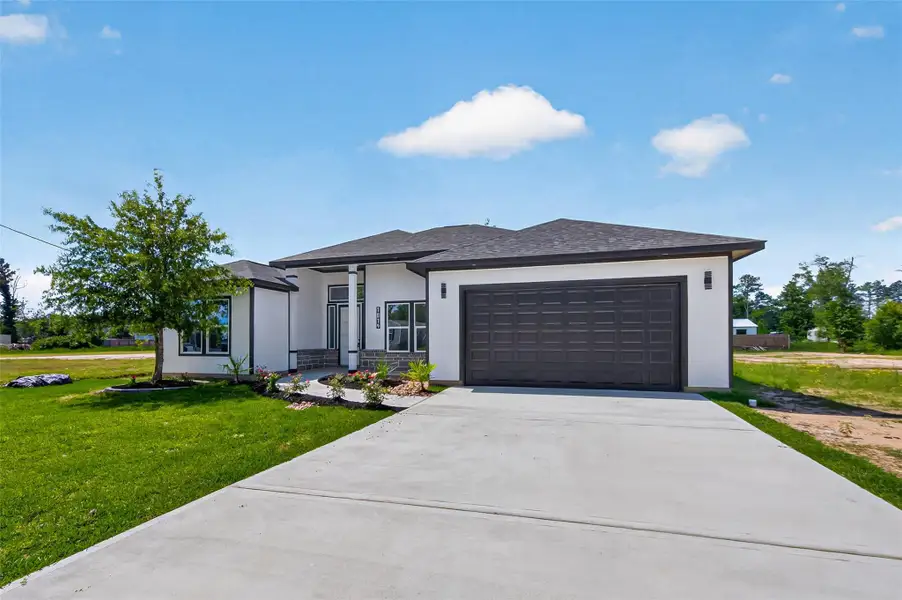 Inviting modern farmhouse exterior with clean architectural lines, charming curb appeal, and thoughtfully designed landscaping.