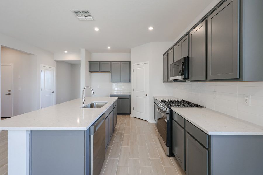 A kitchen with black cabinets.