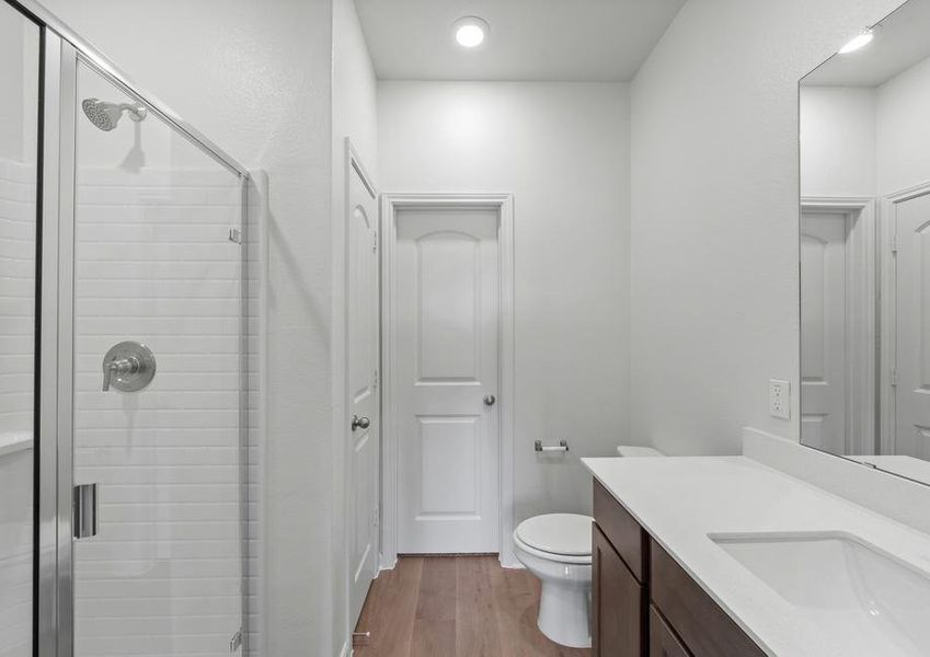 The master bathroom has a large glass, walk-in shower.