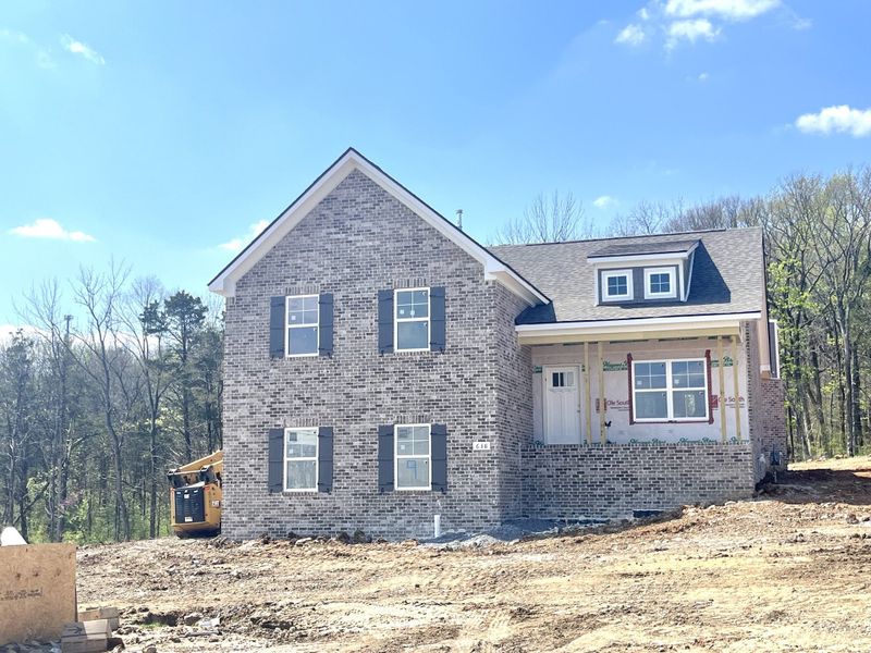 Great looking four sides brick home with dark grey accents and soon to be installed light stone accents on front porch wall and base of columns