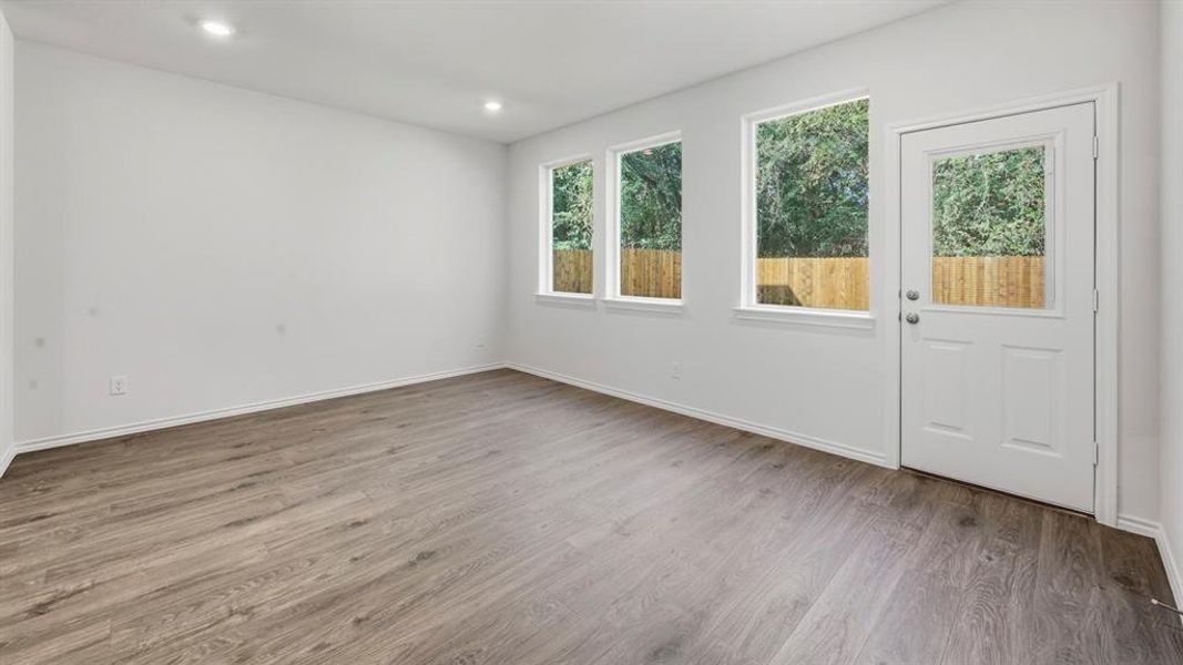 Empty room featuring light wood-style floors and recessed lighting