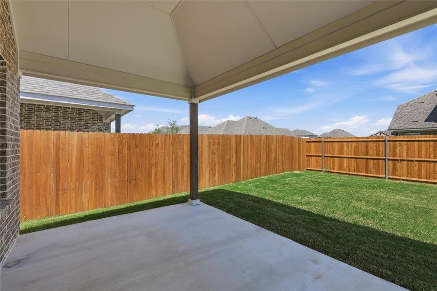 Fenced backyard featuring a patio