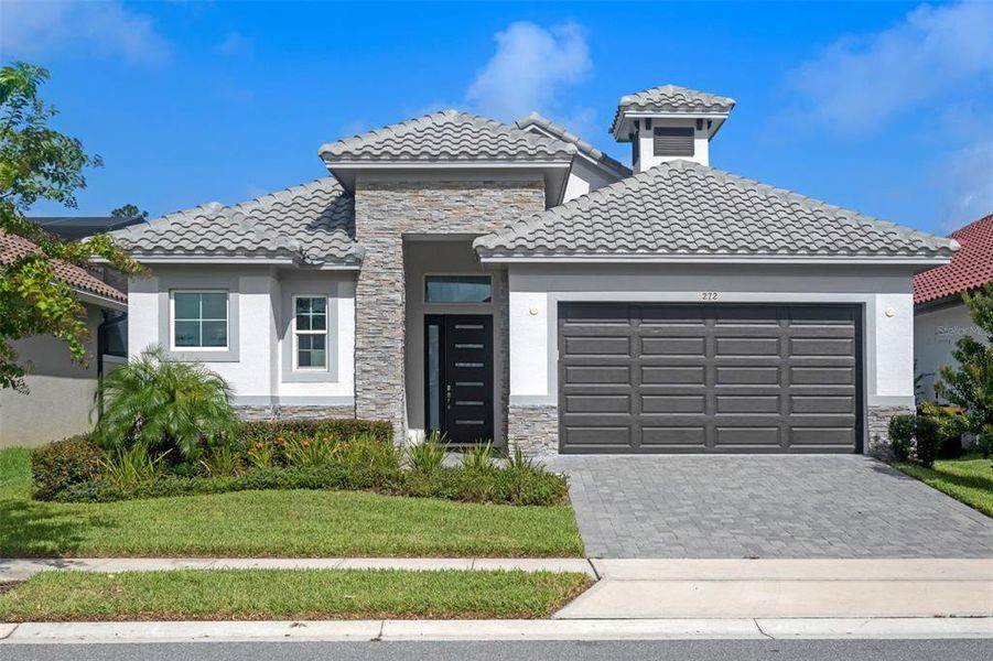 Front exterior of a new home in Hampton Green at Providence, Davenport, FL, highlighting curb appeal (Image 21).