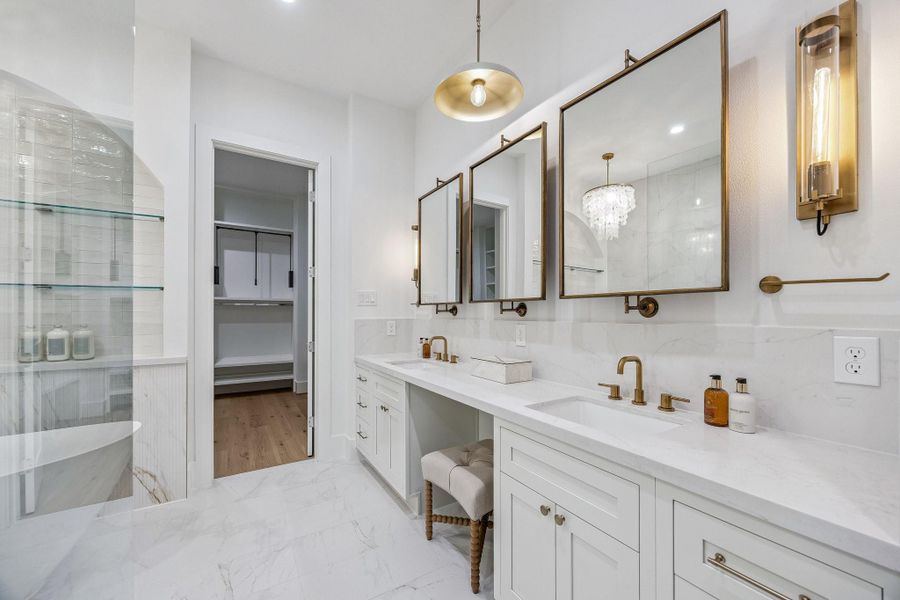 Primary Bath with 12 x 24 Marble Dolomite White Tile Floor. Inset Shaker Style Cabinetry with Soft Close Drawers and Doors. Long Double Vanity with Slab Quartz Counter and Backsplash/Wall. Dual Rectangle Sinks, Dual Widespread Faucets in a Champagne Bronze Finish, Three Pivot Mirrors with a Bronzed Gold Finish, Two LED Sconces with Elongated Clear Glass Cylinder Shades in a Light Brass Finish. There is also a knee space and Separate Commode Area. Primary Bath with 12 x 24 Marble Dolomite White Tile Floor. Inset Shaker Style Cabinetry with Soft Close Drawers and Doors. Long Double Vanity with Slab Quartz Counter and Backsplash/Wall. Dual Rectangle Sinks, Dual Widespread Faucets in a Champagne Bronze Finish, Three Pivot Mirrors with a Bronzed Gold Finish, Two LED Sconces with Elongated Clear Glass Cylinder Shades in a Light Brass Finish. There is also a knee space and Separate Commode Area.