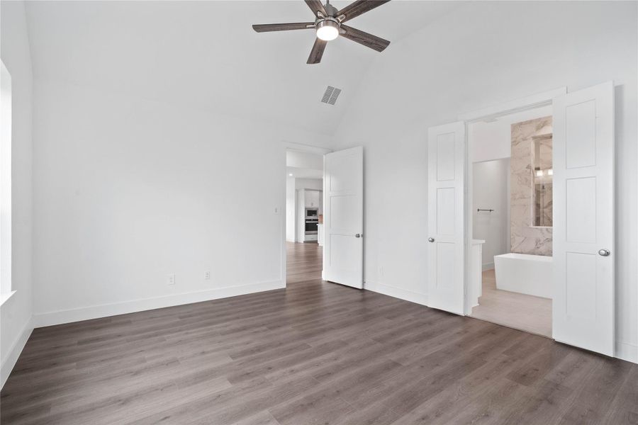 Additional view from primary bedroom looking towards the double door entrance to primary bathroom.