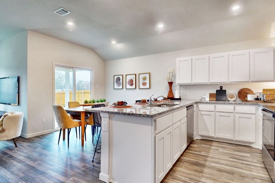 A kitchen with white cabinets.