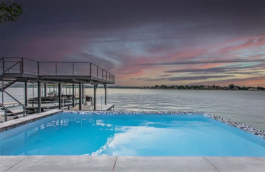View of pool with a boat dock, boat lift, and a water view