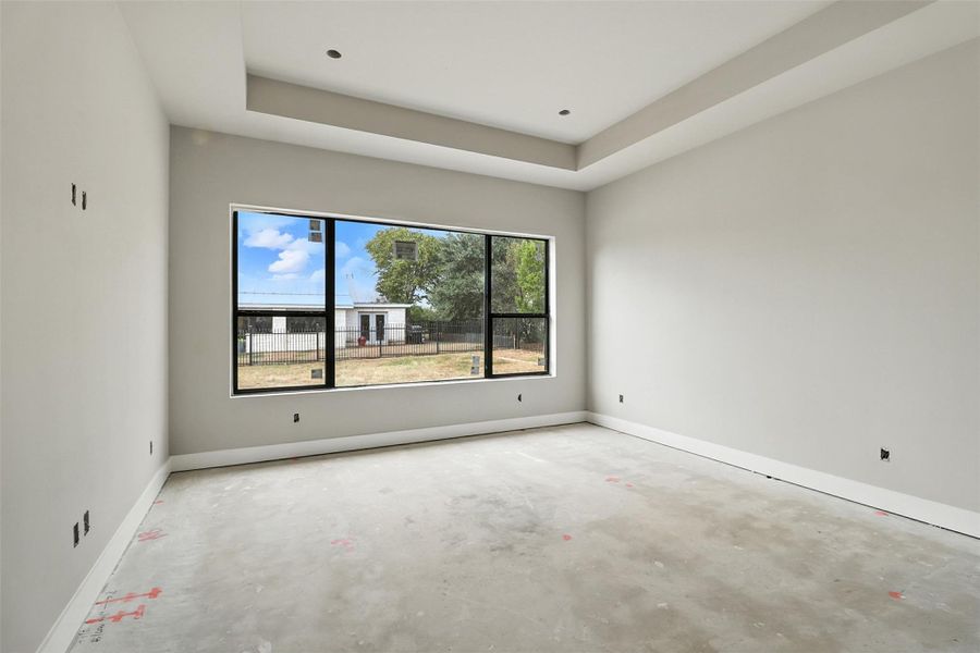 Spare room featuring concrete flooring and a raised ceiling Spare room featuring concrete flooring and a raised ceiling