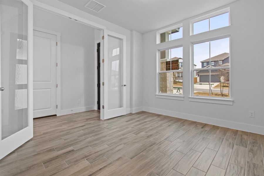 Empty room featuring a healthy amount of sunlight and french doors