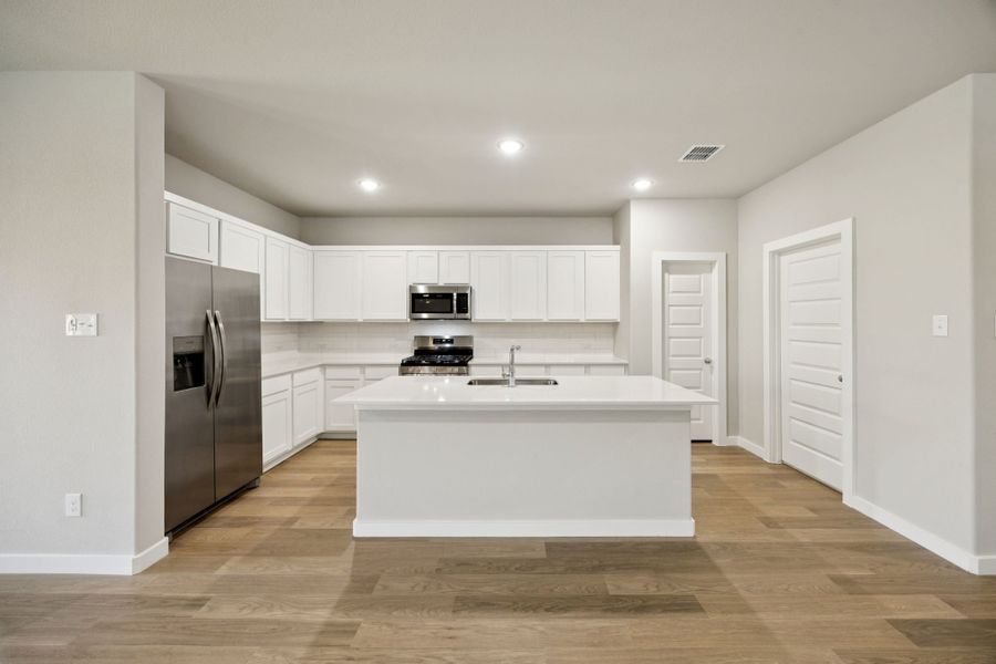 Kitchen in the Oscar home plan by Trophy Signature Homes – REPRESENTATIVE PHOTO