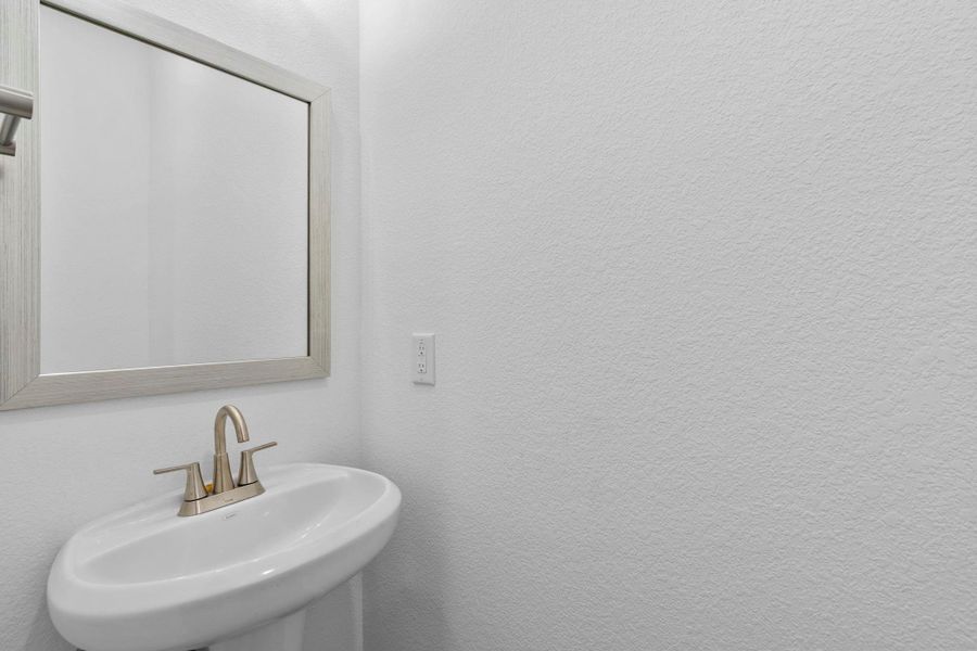 This charming home features a beautifully appointed half bath adjacent to the family room, perfect for welcoming guests and adding convenience to your daily life.