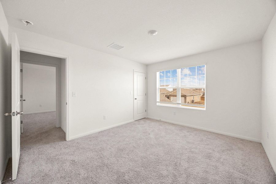 Spare room featuring light carpet and baseboards