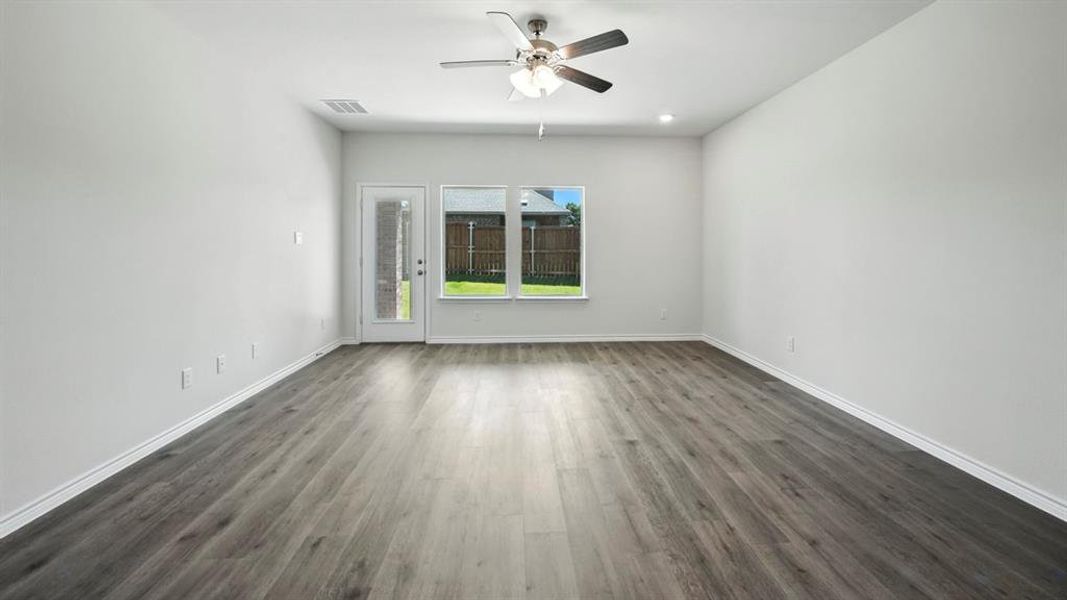 Unfurnished room featuring dark wood-style floors, a ceiling fan, and recessed lighting Unfurnished room featuring dark wood-style floors, a ceiling fan, and recessed lighting