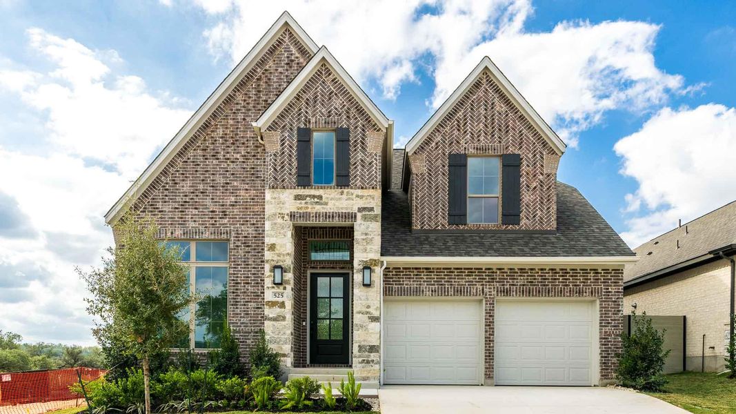 Front exterior of a new home in Wolf Ranch 51', Georgetown, TX, highlighting curb appeal (Image 1).