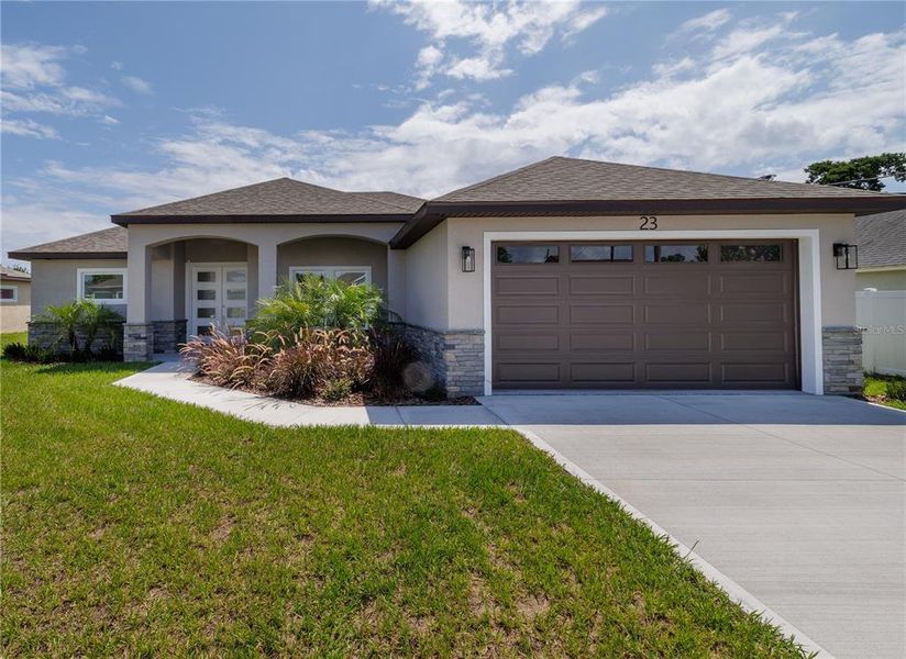 Front exterior of a new home in , Palm Coast, FL, highlighting curb appeal (Image 18).