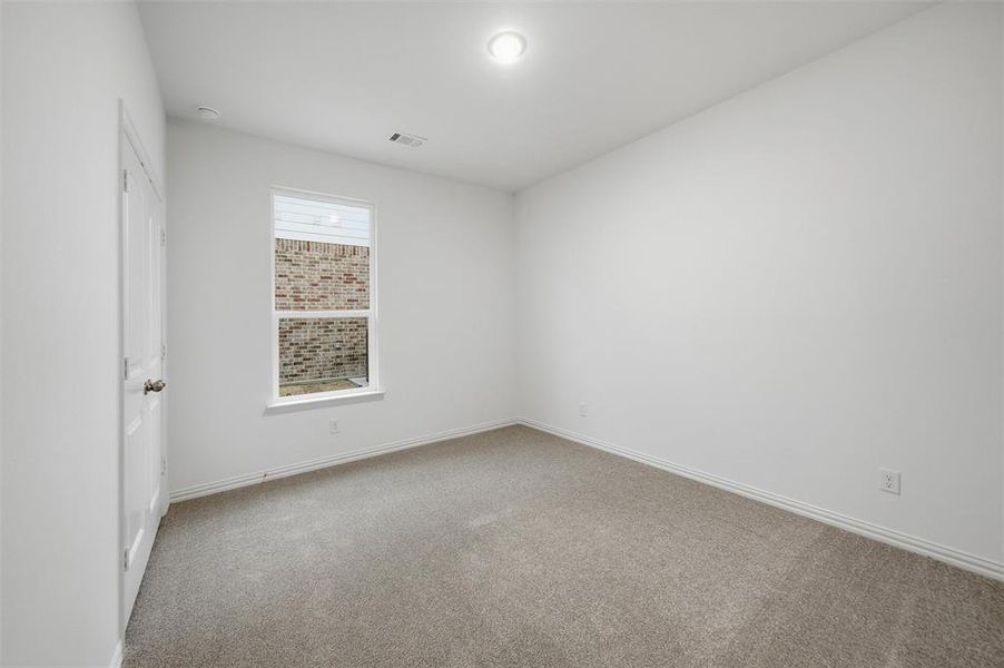 Spare room with light carpet and baseboards